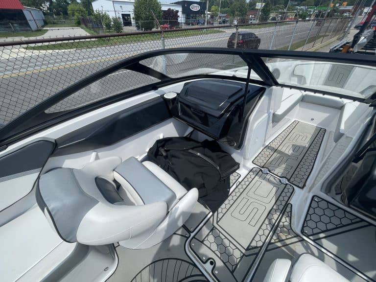 Interior view of a 2018 Scarab 195 G boat with seating and controls.