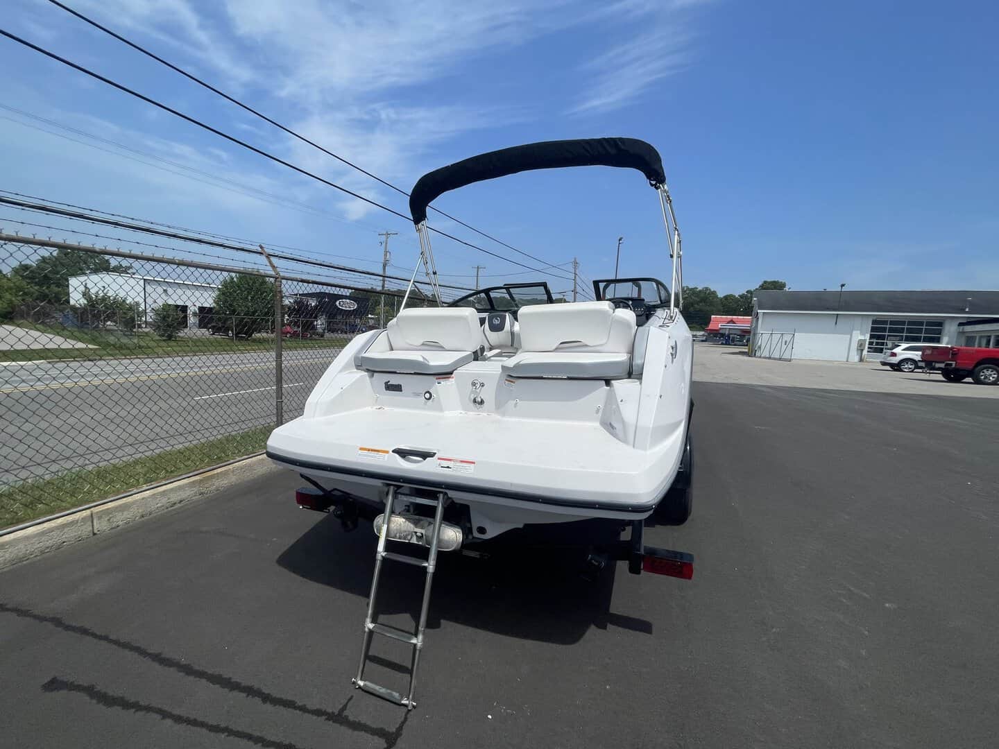 White 2018 Scarab 195 G boat on trailer at Hall's Sport Center.