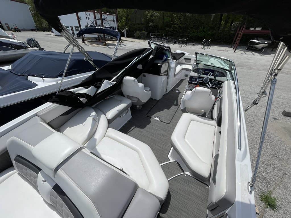 Modern white motorboat with spacious seating at Hall's Sport Center marina.