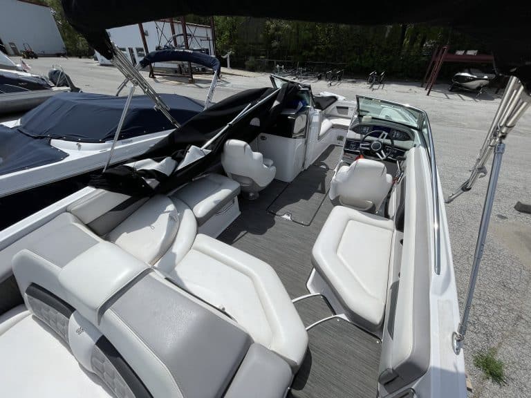 Modern white motorboat with spacious seating at Hall's Sport Center marina.