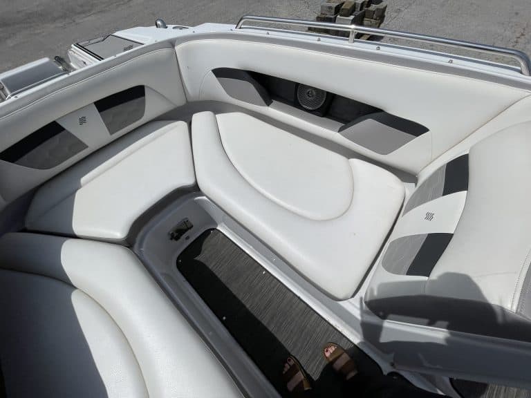 Boat interior with white cushioned seats and modern design.