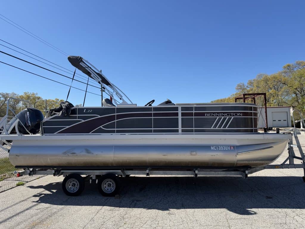 Pontoon boat on trailer at Hall's Sport Center, ready for water recreation and boating adventures.