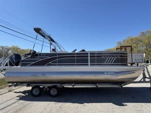 Pontoon boat on trailer at Hall's Sport Center, ready for water recreation and boating adventures.
