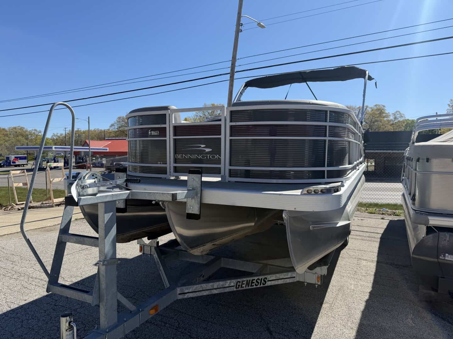 Pontoon boat on display at Hall's Sport Center, perfect for lake fun and water recreation.