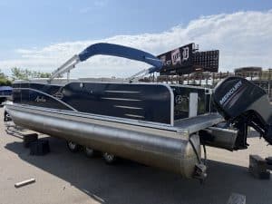 Pontoon boat with Mercury outboard motor and canopy at Hall's Sport Center.