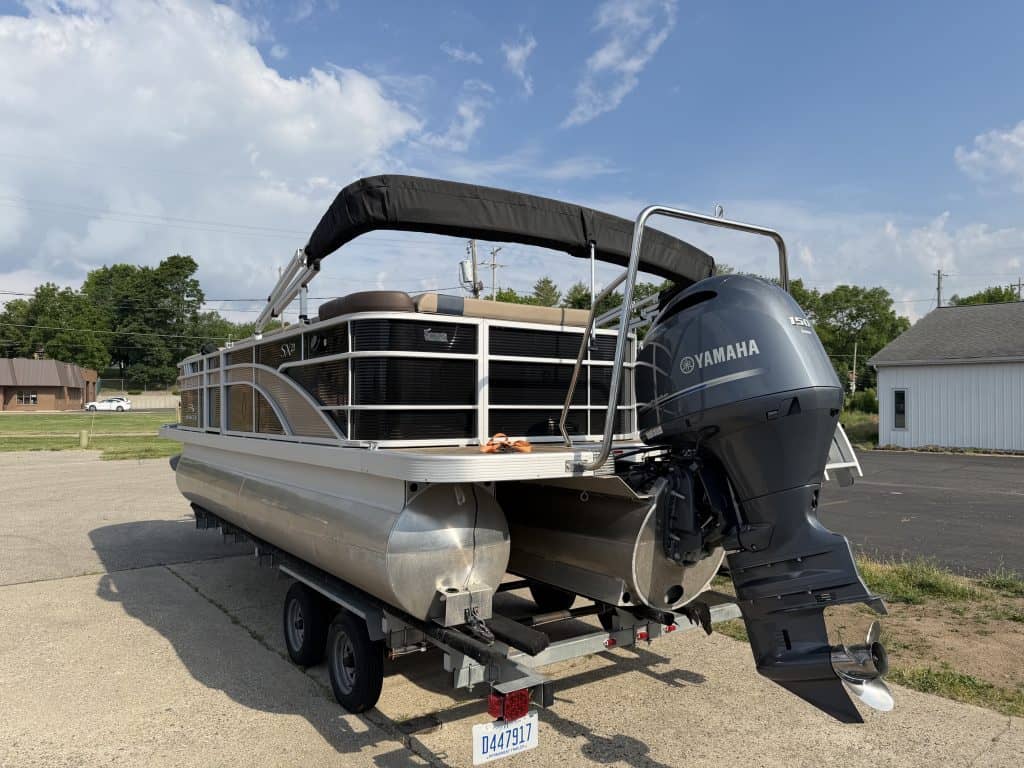 Bennington 21SXL pontoon boat with Yamaha engine on trailer.