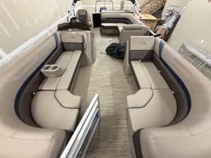 Interior view of a Bennington 21SXL pontoon boat with seating and steering console.