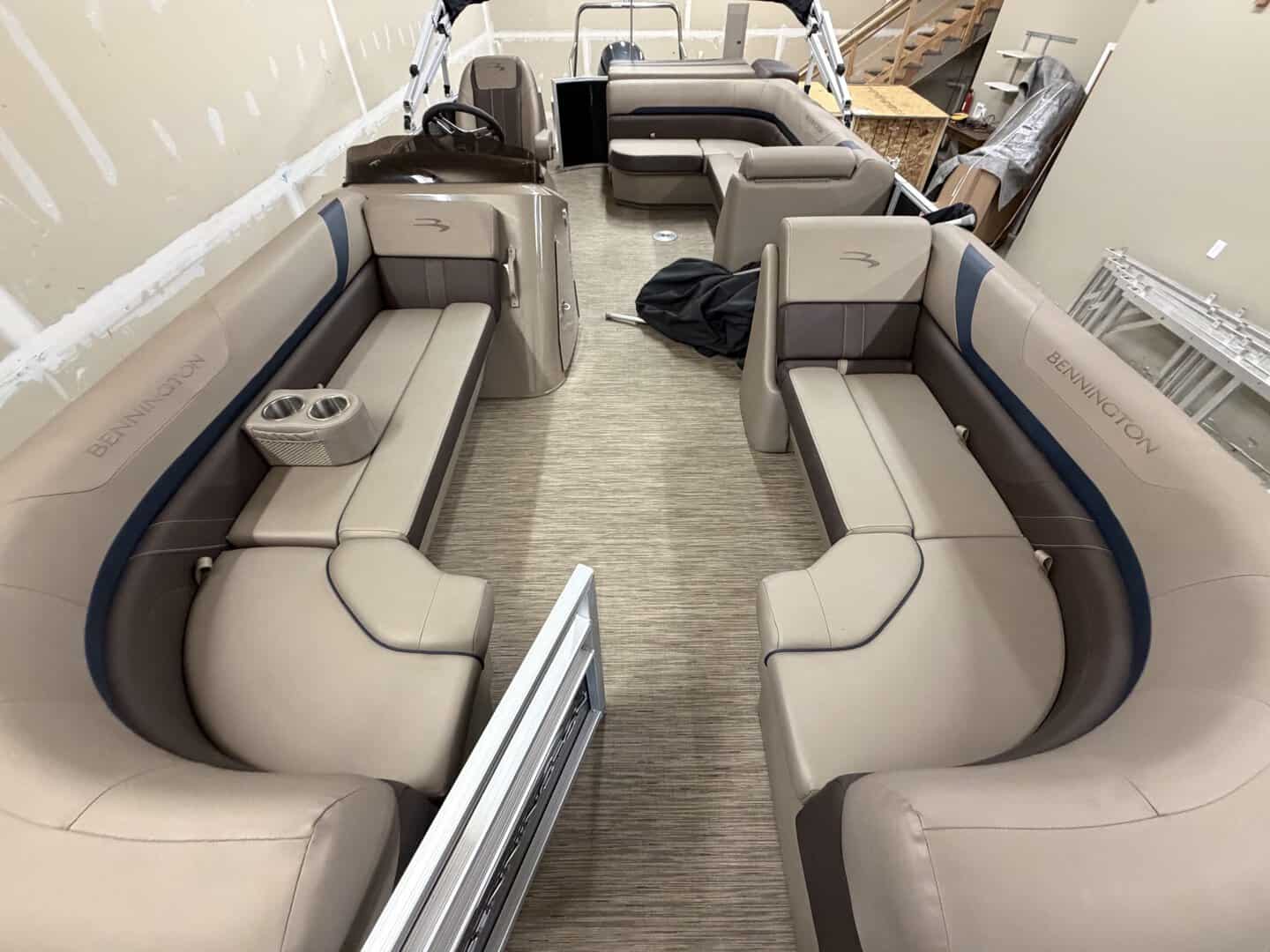 Interior view of a Bennington 21SXL pontoon boat with seating and steering console.