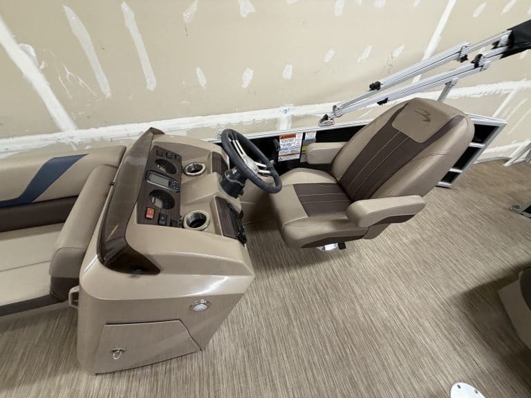 Boat console with steering wheel and controls at Hall's Sport Center.