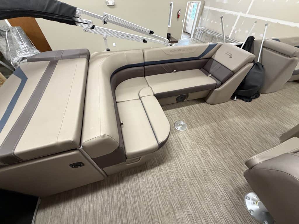 Luxury boat seating with beige and dark gray upholstery at Hall's Sport Center.