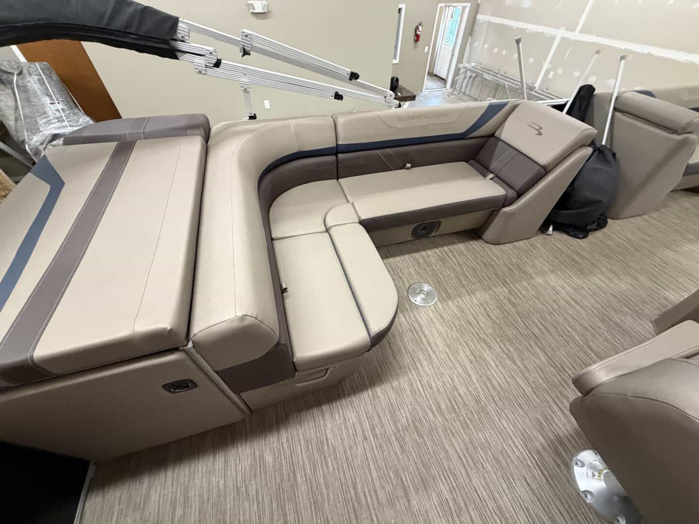 Luxury boat seating with beige and dark gray upholstery at Hall's Sport Center.