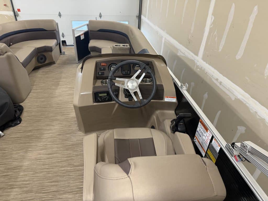 Close-up of the steering console and seating in a Bennington 21SXL pontoon boat.