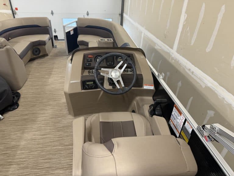 Close-up of the steering console and seating in a Bennington 21SXL pontoon boat.