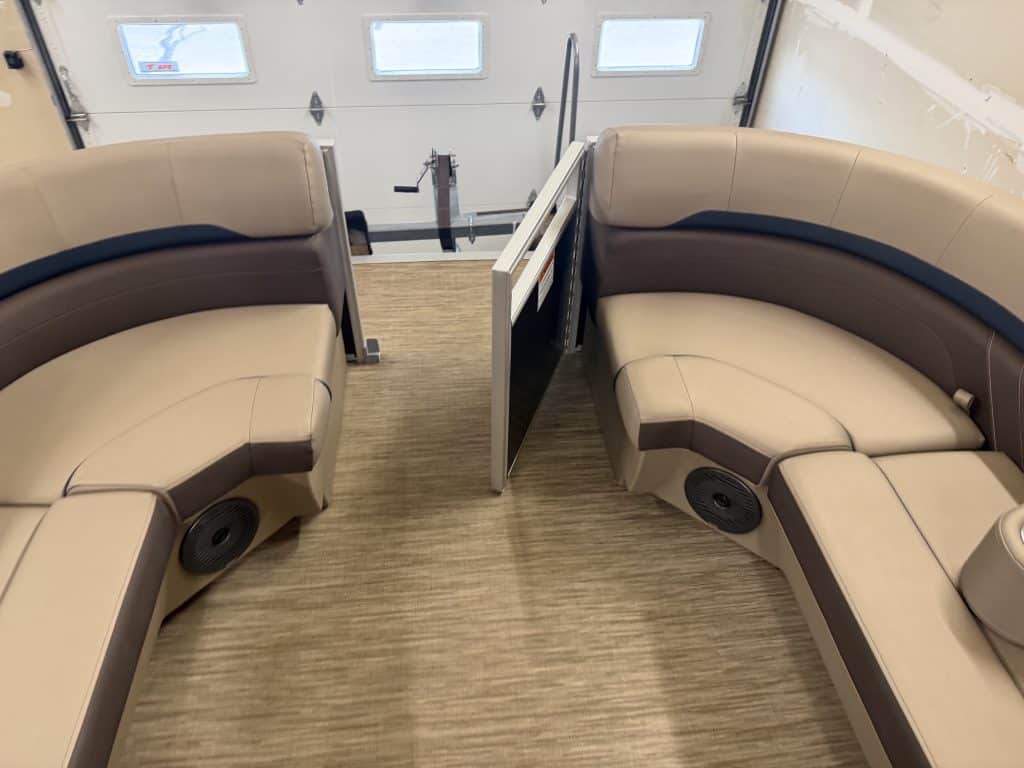 Comfortable boat seating with built-in speakers and a divider.
