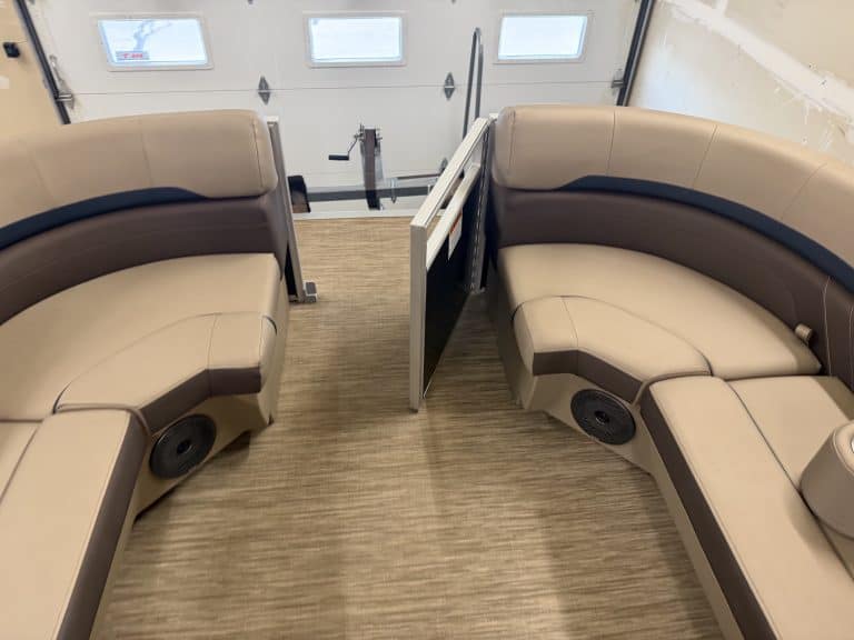 Comfortable boat seating with built-in speakers and a divider.