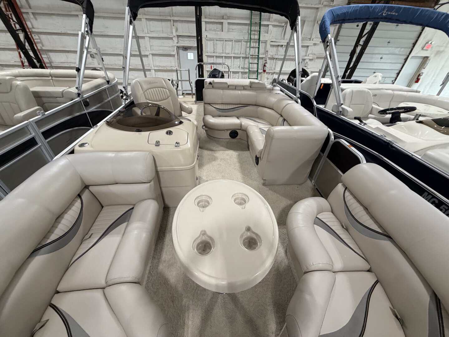 Luxury 2010 Berkshire 223 SLX pontoon boat with seating and canopy.