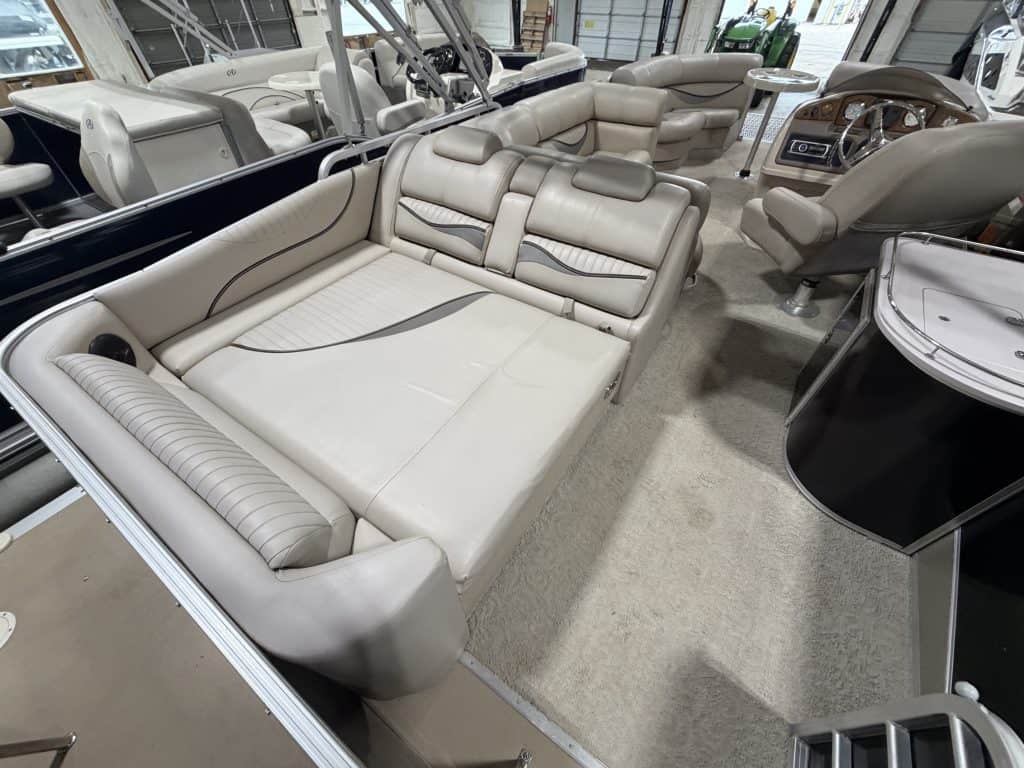 Elegant beige boat seating with plush cushions and armrests.