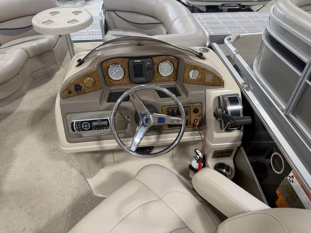 Close-up of Berkshire 223 SLX boat dashboard with steering wheel and gauges.