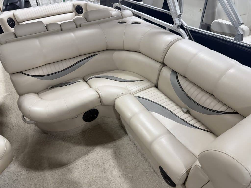 Elegant white boat seating with plush cushions and built-in speakers.