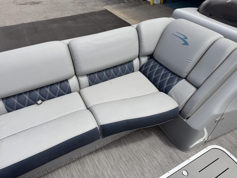Comfortable boat seating with white and navy upholstery at Hall's Sport Center.