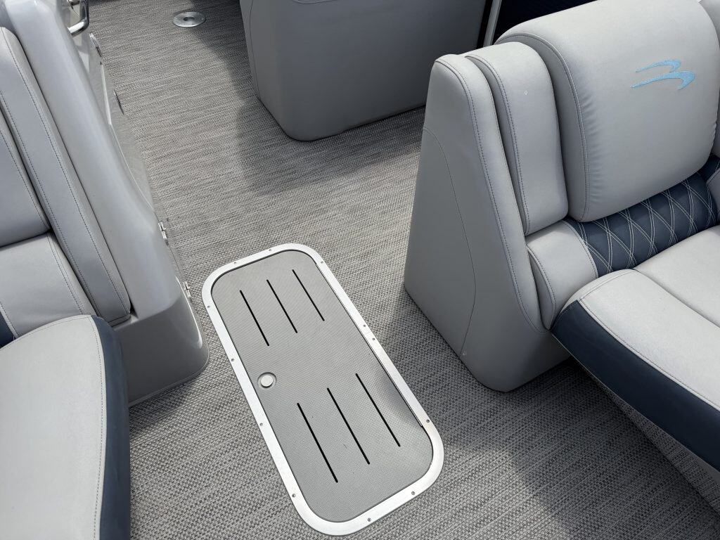 Close-up of boat interior with seating and floor mat at Hall's Sport Center.