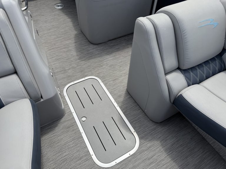 Close-up of boat interior with seating and floor mat at Hall's Sport Center.