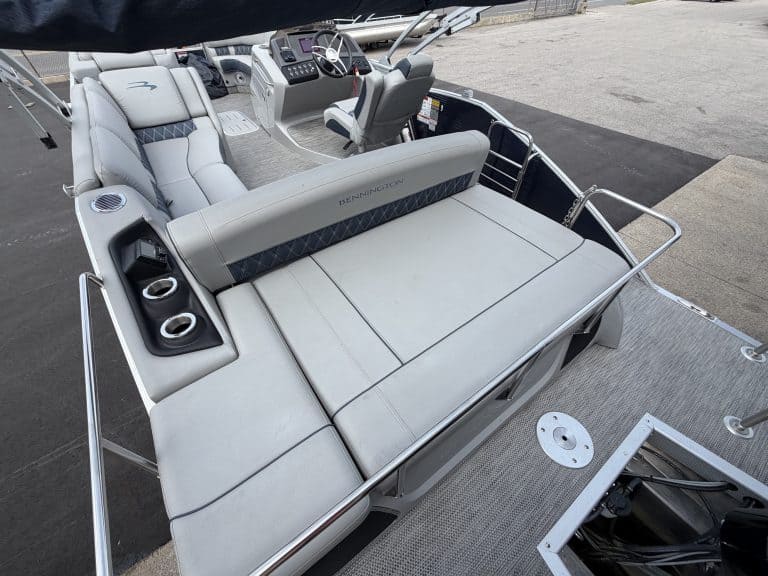 Luxury pontoon boat interior with seating and steering console.