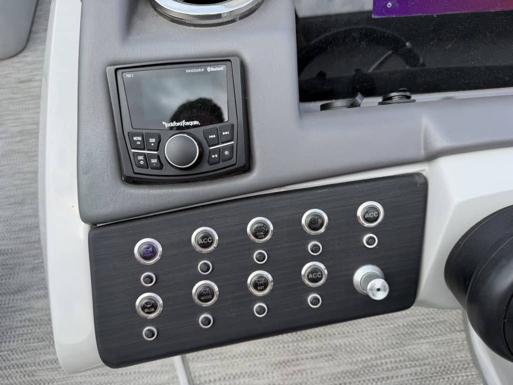 Boat dashboard with control panel and electronic display for Bennington 25QSB.