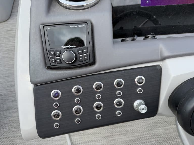 Boat dashboard with control panel and electronic display for Bennington 25QSB.