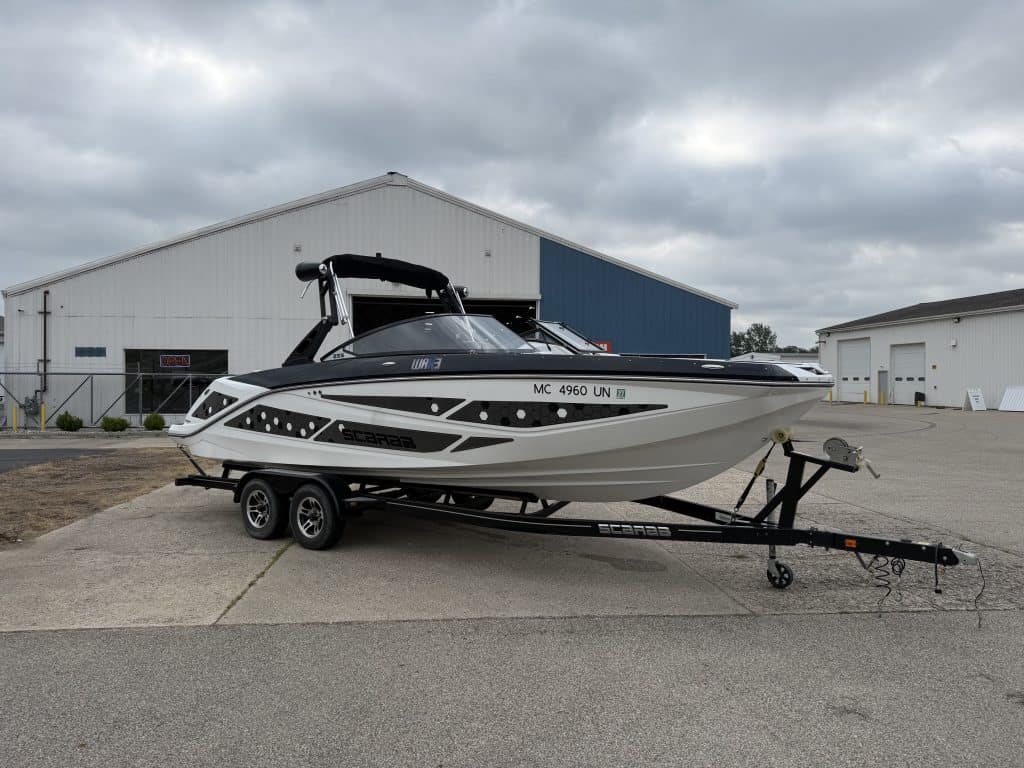 Luxury 2021 Scarab 255ID powerboat on trailer at marina.
