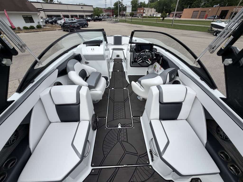 Interior view of a modern boat at Hall's Sport Center with seating and steering wheel.