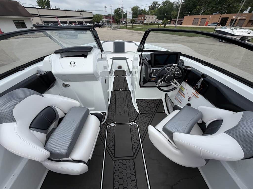 Modern boat cockpit with steering wheel and seating at Hall's Sport Center.