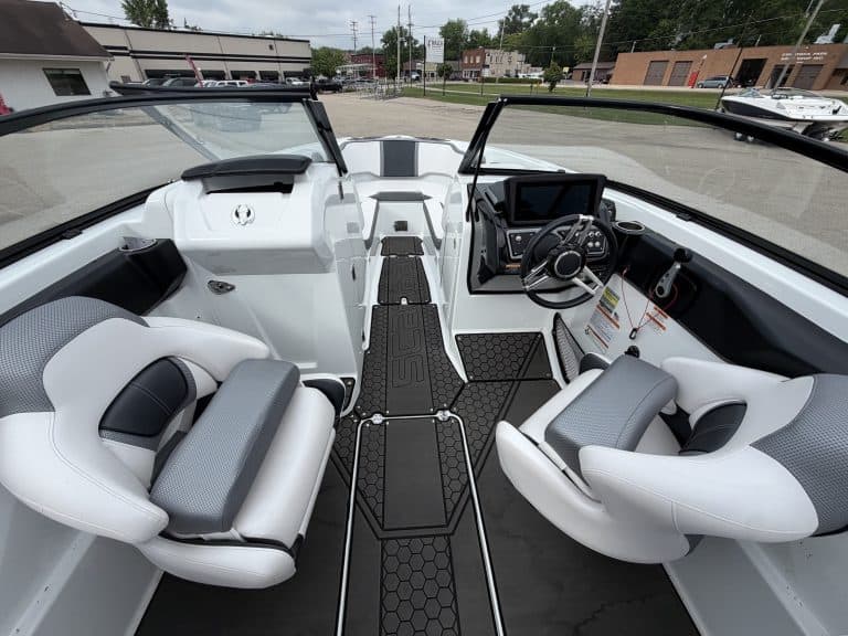 Modern boat cockpit with steering wheel and seating at Hall's Sport Center.