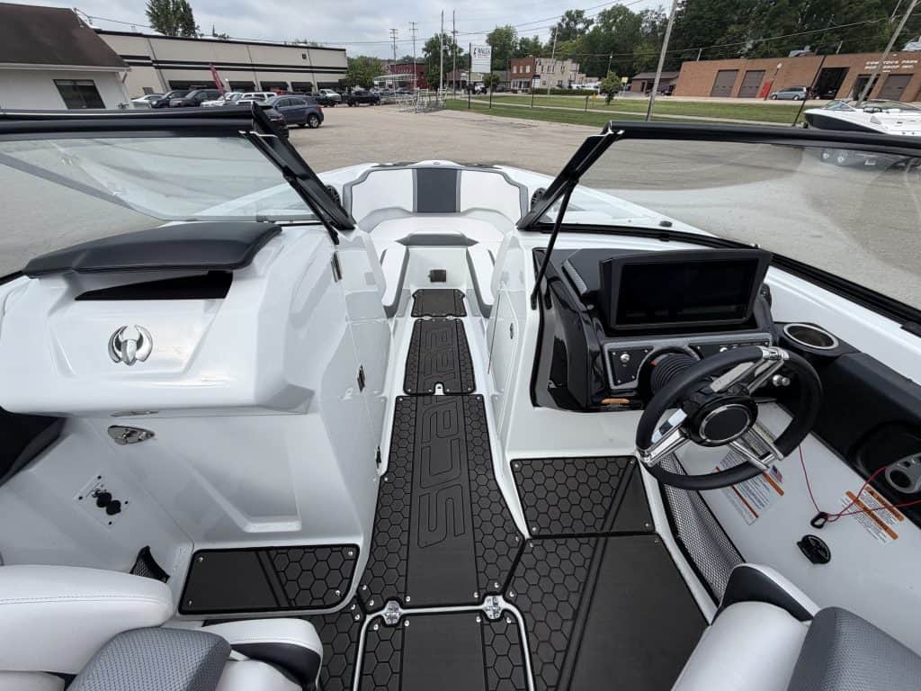 Interior view of a 2021 Scarab 255ID boat with steering wheel and dashboard.