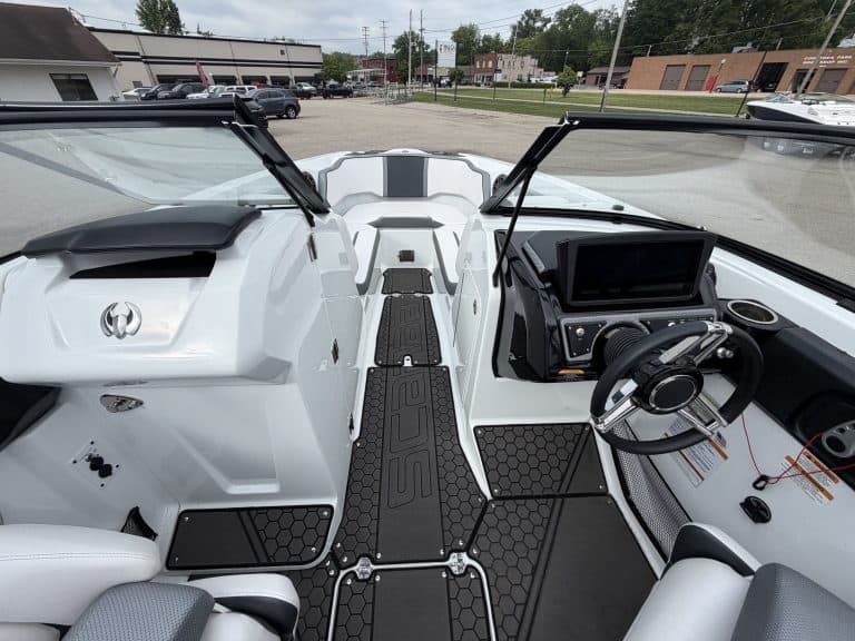 Interior view of a 2021 Scarab 255ID boat with steering wheel and dashboard.