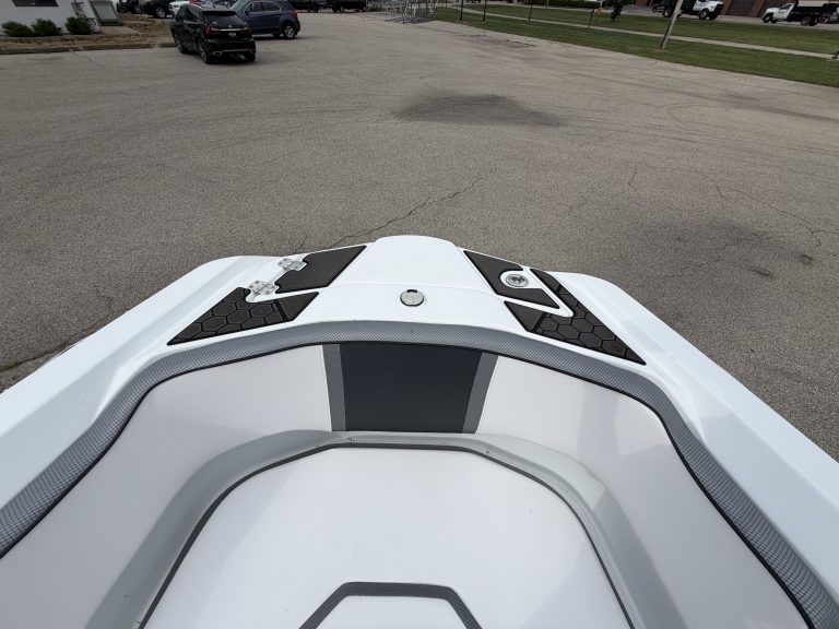 Close-up of the bow of a 2021 Scarab 255ID jet boat in a parking lot.