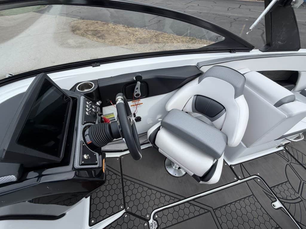 Interior view of a 2021 Scarab 255ID boat with steering and seating.