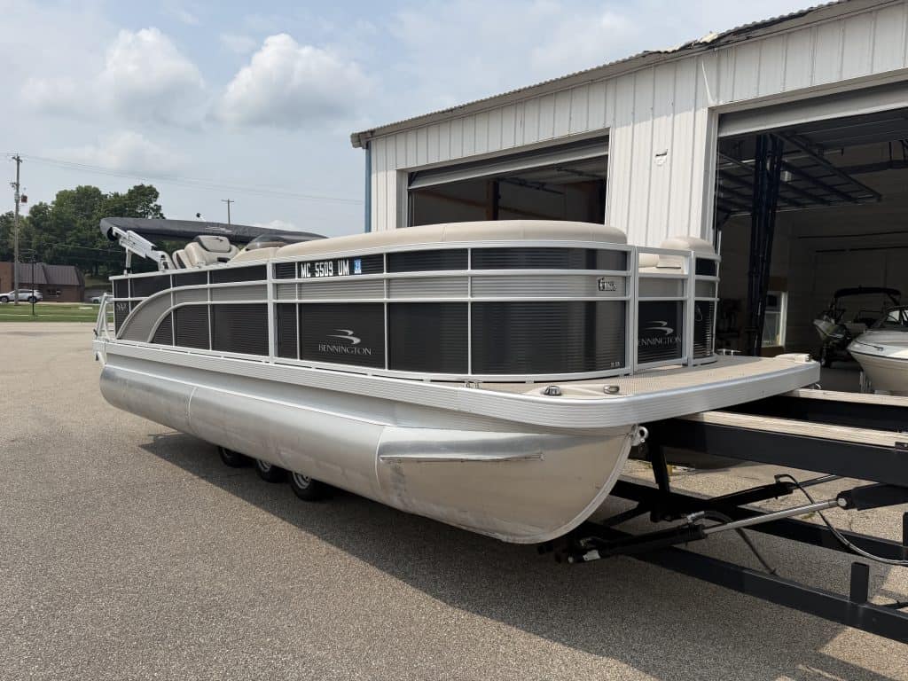 Bennington 21 SS pontoon boat parked outside a building.