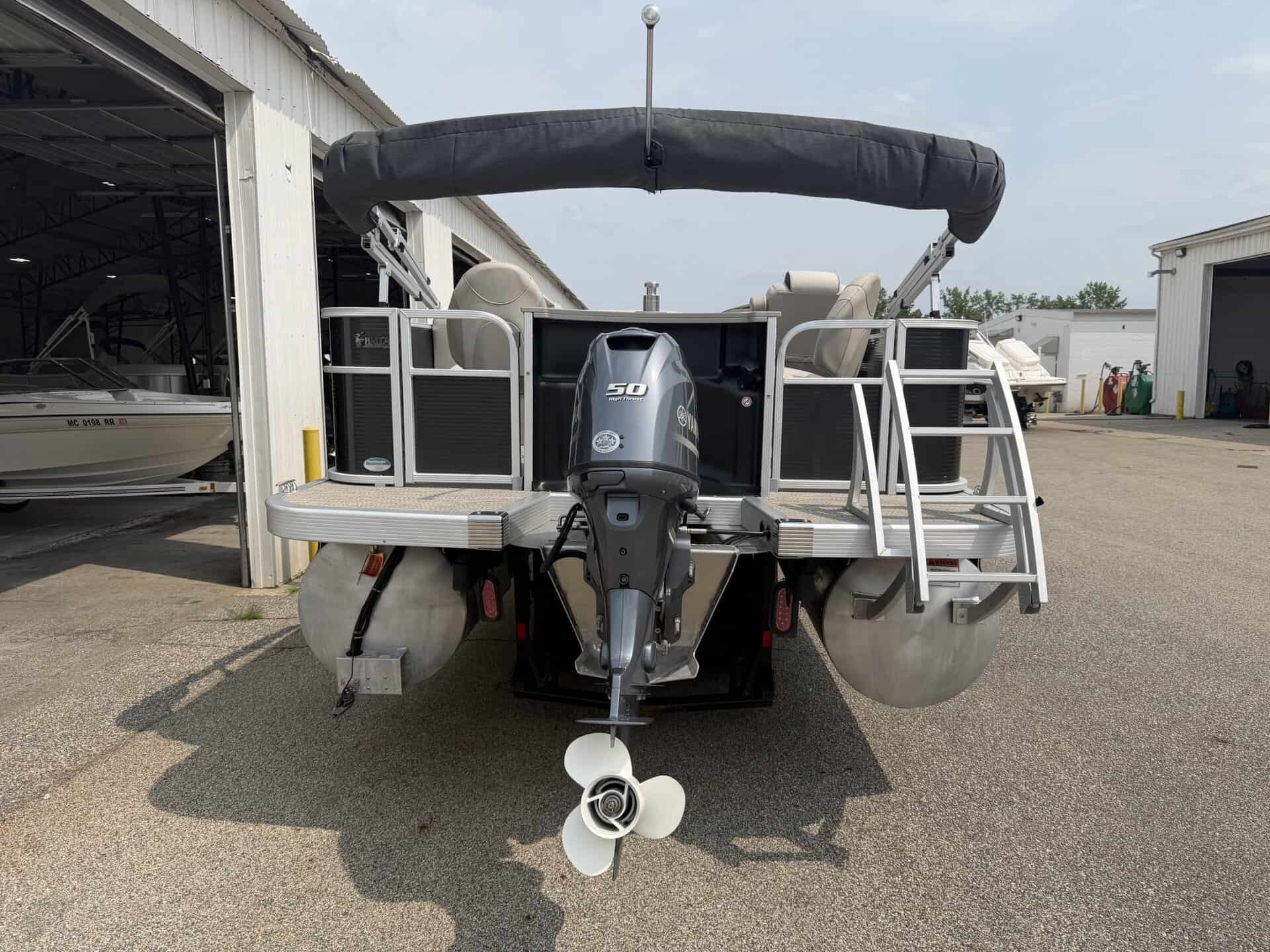 Bennington 21 SS pontoon boat with outboard motor at Hall's Sport Center.
