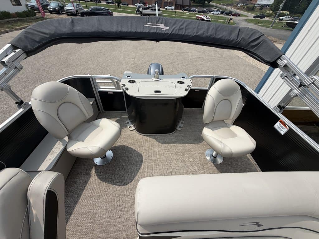 Pontoon boat interior with two captain chairs and a rear bench seat.