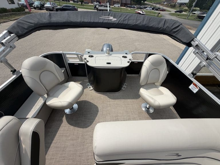 Pontoon boat interior with two captain chairs and a rear bench seat.