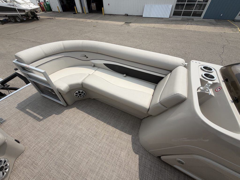 Luxury Bennington 21 SS pontoon boat with white seating and modern design.