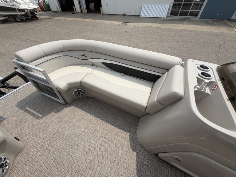 Luxury Bennington 21 SS pontoon boat with white seating and modern design.