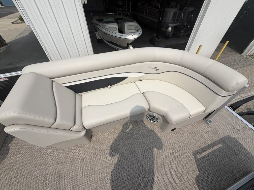 Luxury Bennington 21 SS pontoon boat with white seating and black accents.