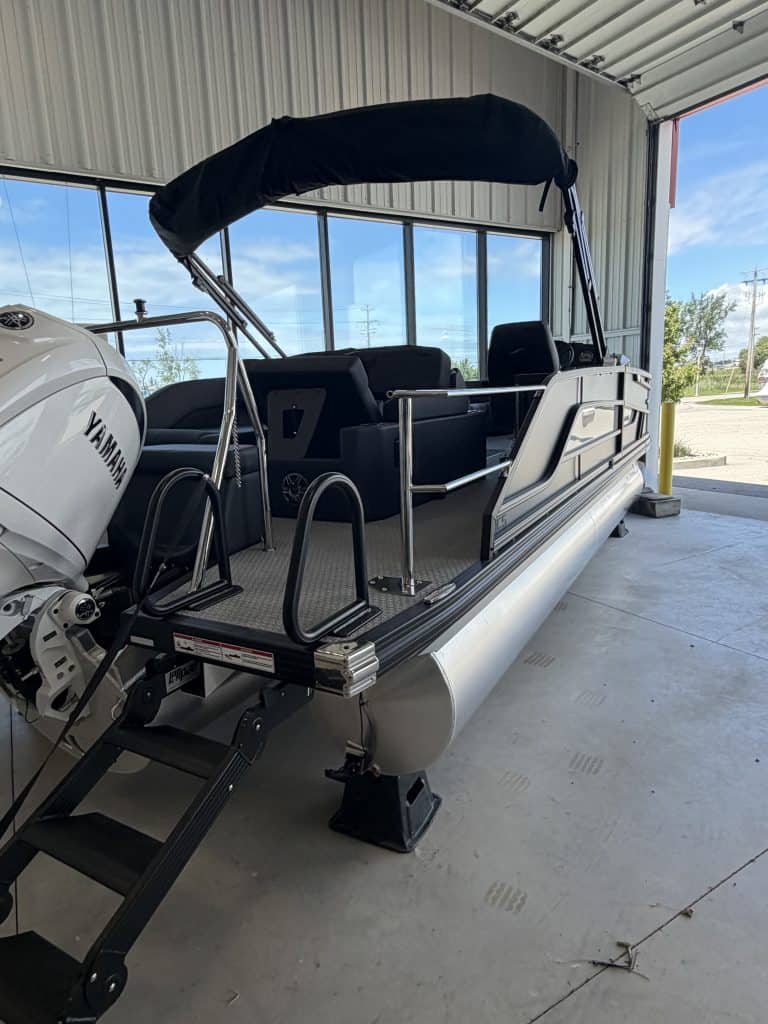 Pontoon boat at Hall's Sport Center with Yamaha engine and canopy.