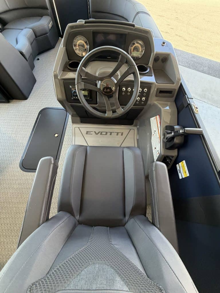Boat helm station with steering wheel and controls at Hall's Sport Center.