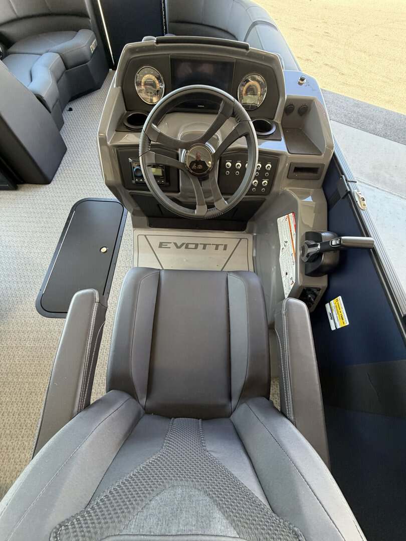 Boat helm station with steering wheel and controls at Hall's Sport Center.