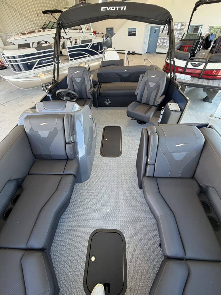 Luxury pontoon boat with seating and canopy at Hall's Sport Center.