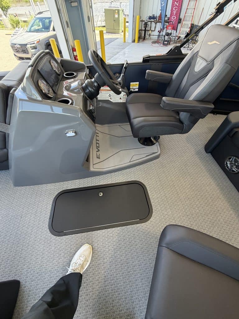 Bus driver cockpit with steering wheel and controls at Hall's Sport Center.