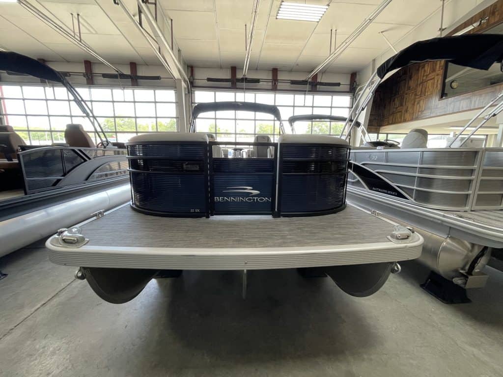 Pontoon boat on display at Hall's Sport Center, showcasing watercraft and boating accessories.